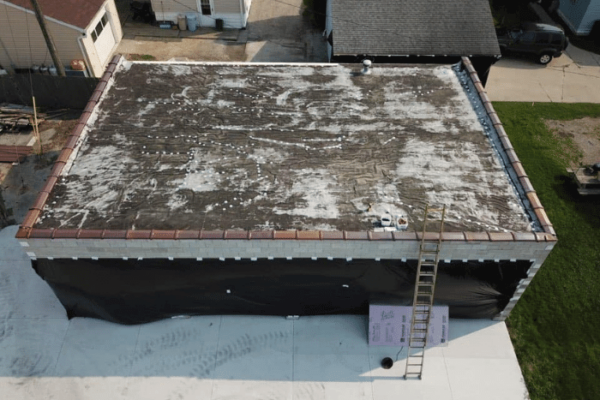 The before photo of a commercial roof project using spray foam insulation.