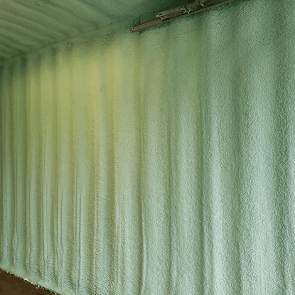 Shipping container with spray foam insulation.